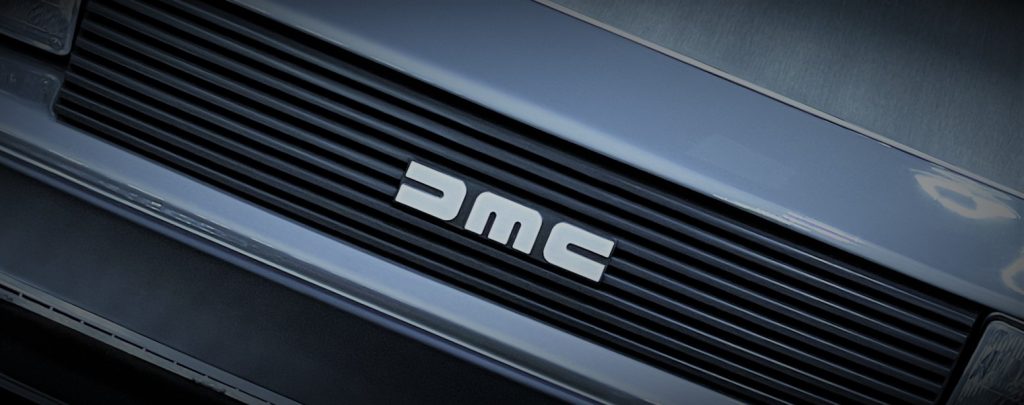 stylized dmc badge on a delorean dmc-12
