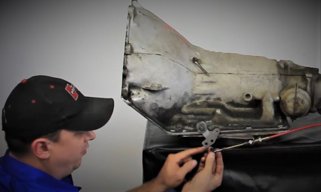 Man Adjusting B&M Shifter Cable on Racing Transmission