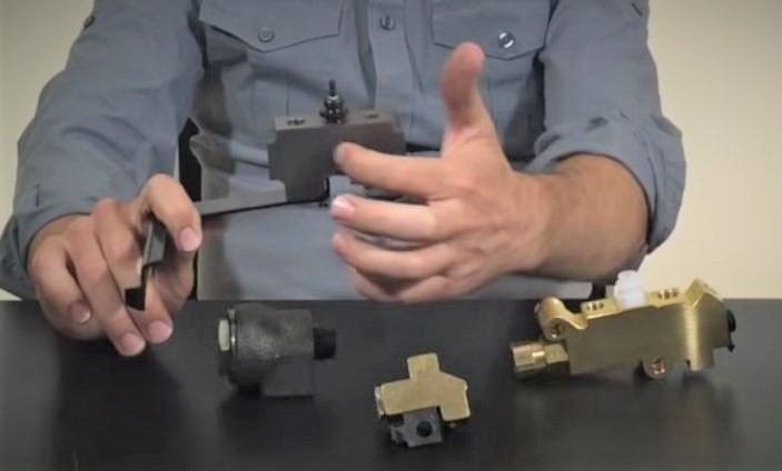 Man holding automotive brake components