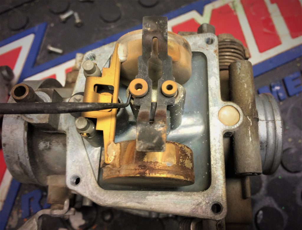 small hook tool used to pry out a carburetor jet