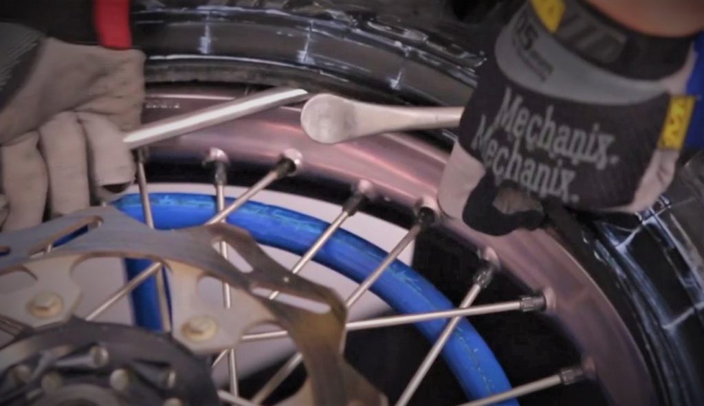 Man Changing a dirt bike tire