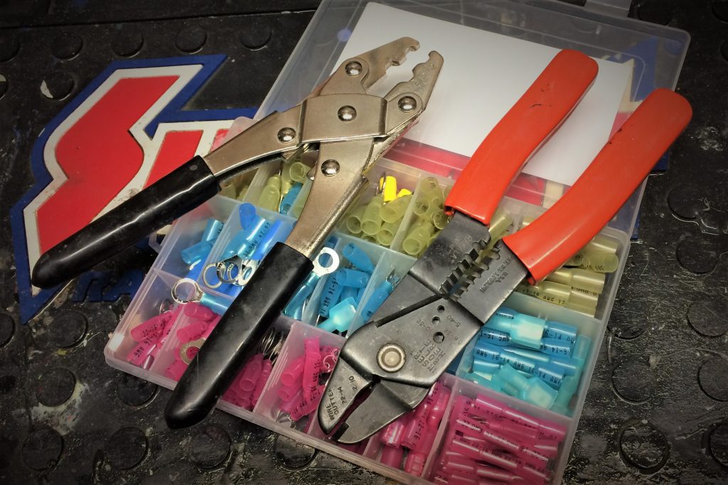 wire crimping tools and crimp connectors on a workbench