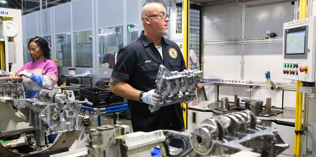 Workers assemble engine blocks at General Motors Flint Engine Operations facility in Michigan
