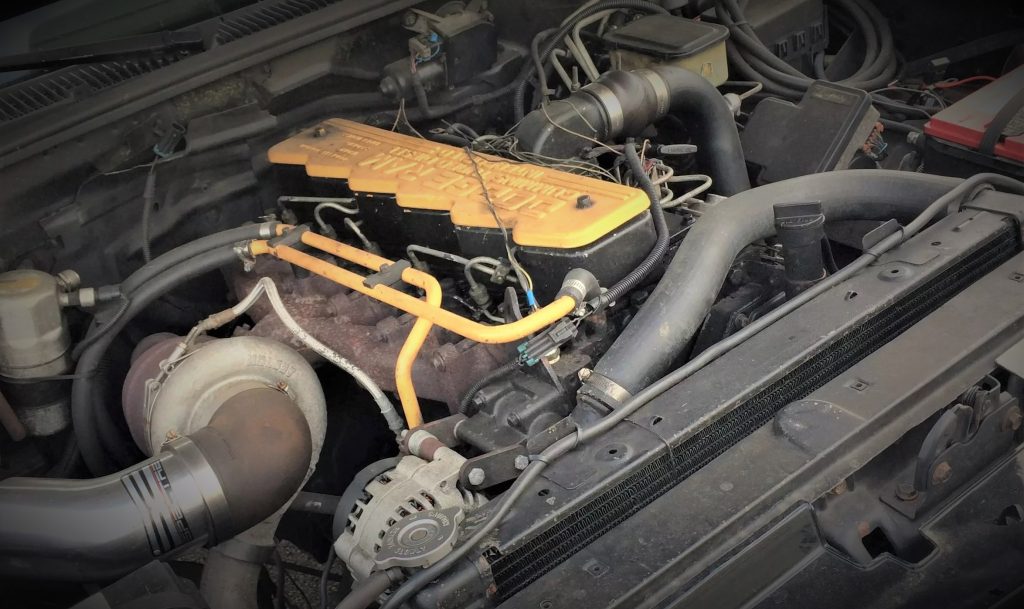 engine bay with cummins ram diesel engine in a gmc sierra pickup truck