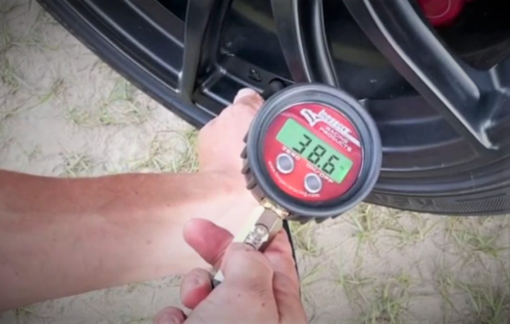 Man Using a Longacre Racing Tire Gauge