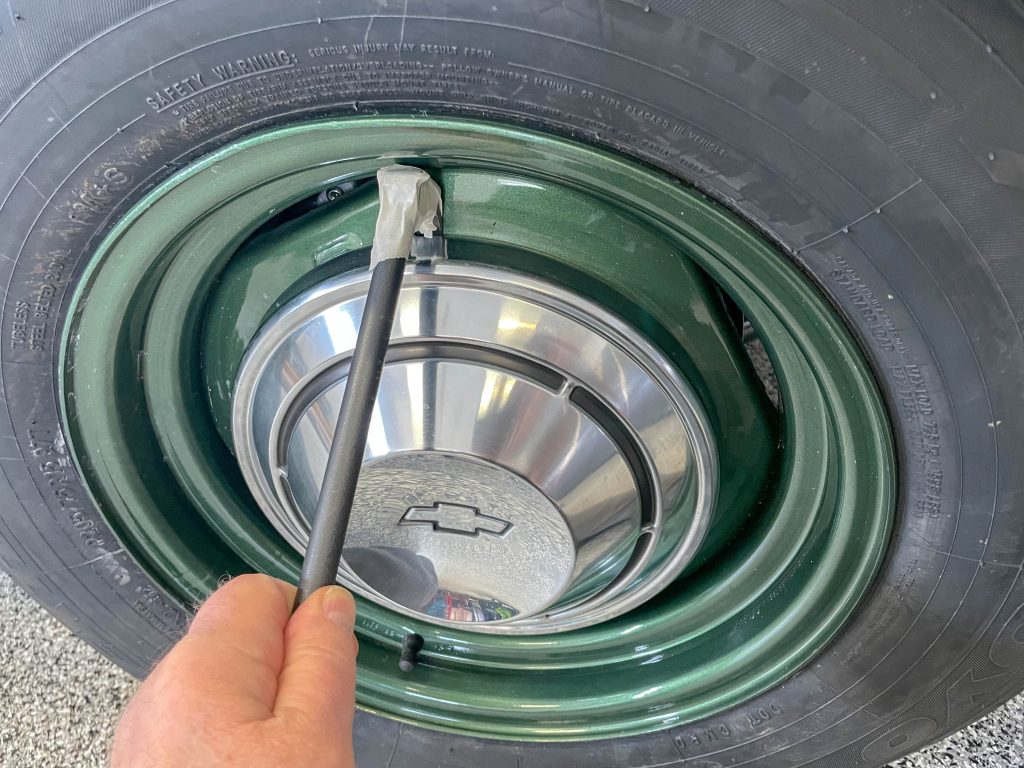 rolling head pry bar used to remove a dog dish hubcap on an old car