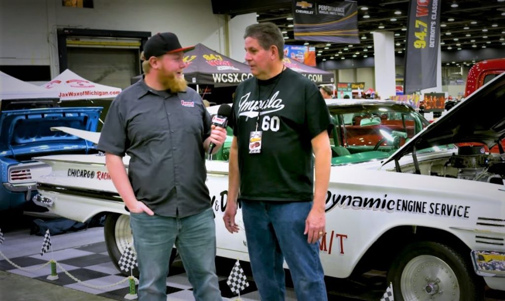 Two Men Talking Near a 1960 Impala Nostalgia Drag Car