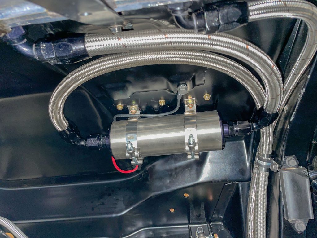 external electric fuel pump mounted underneath trunk in a classic car