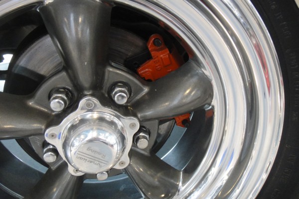 custom wheel and brake caliper on a classic car