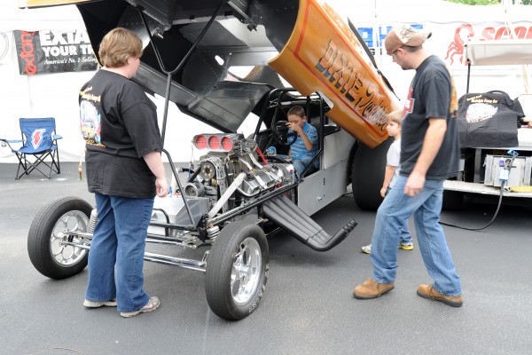 boy sitting in cockpit of a vintage nostalgia nhra funny car