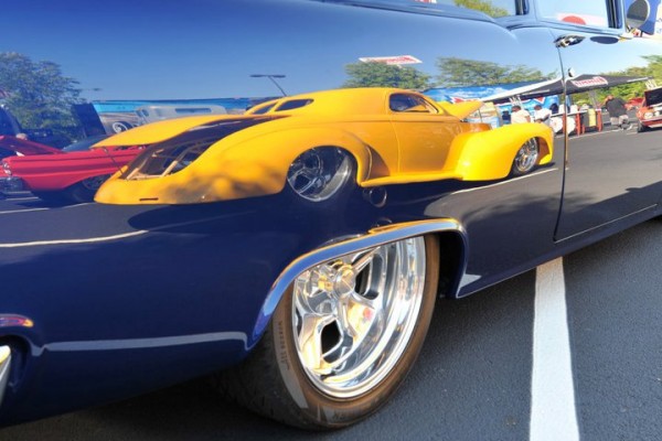 reflection of a hot rod in a classic car fender