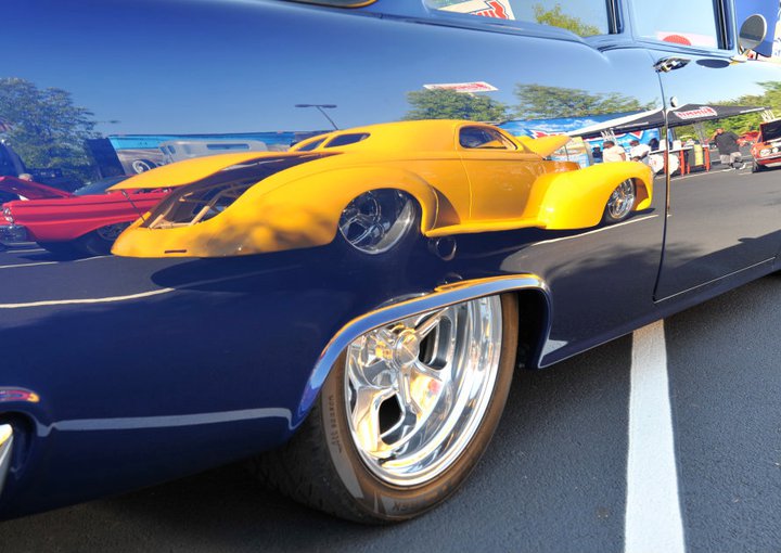 reflection of a hot rod in a classic car fender