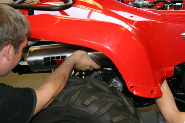 installing an aftermarket muffler on an Atv
