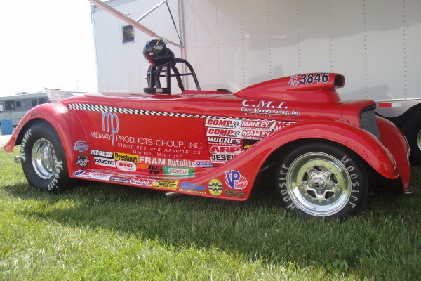 altered dragster in pits near trailer
