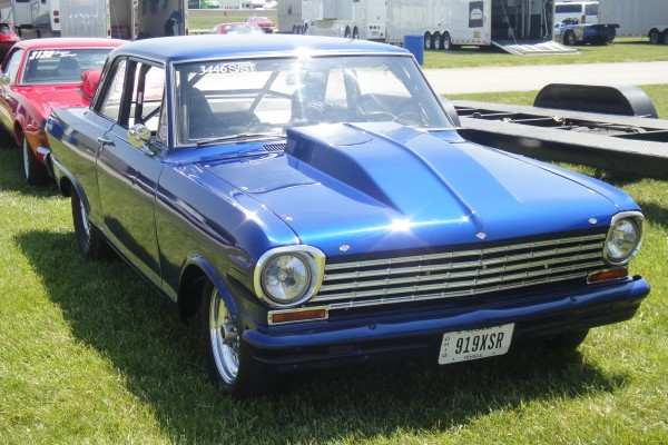 chevy 2 nova drag car near trailer