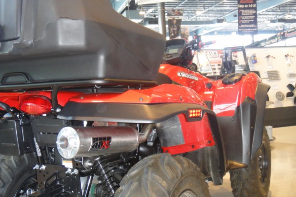 ATV loaded up with aftermarket gear, exhaust view