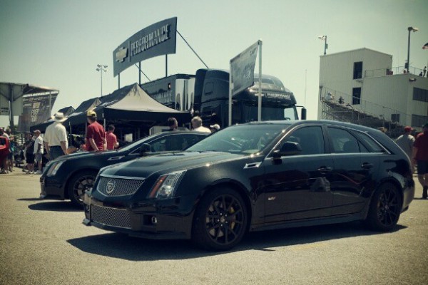 a pair of cadillac cts-v wagons at a car show