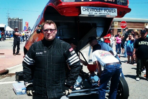 men working on a vintage Chevy nitro funny car