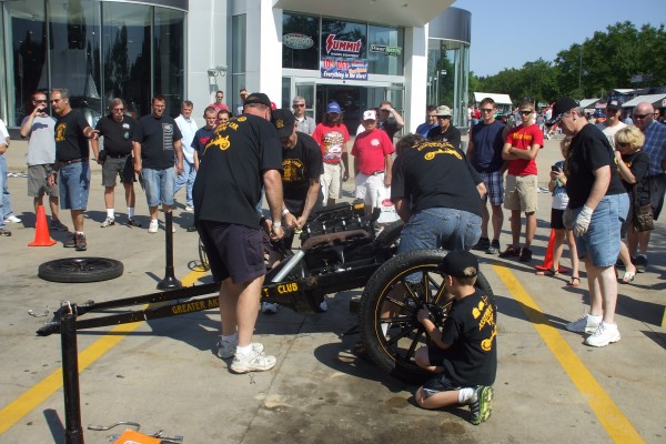 men assembling a ford model t demonstration, fitting engine