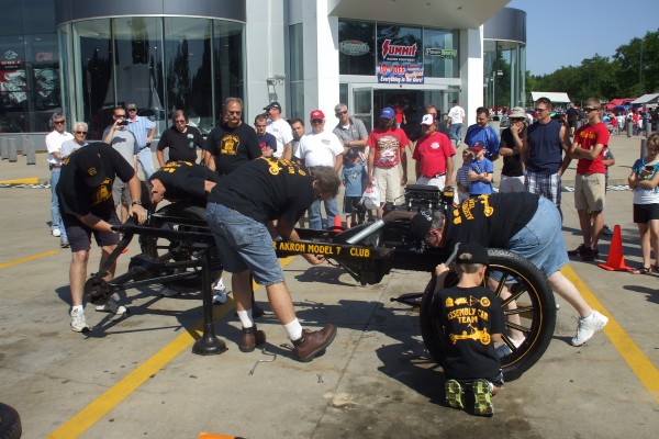men assembling a ford model t demonstration, fitting rear axle