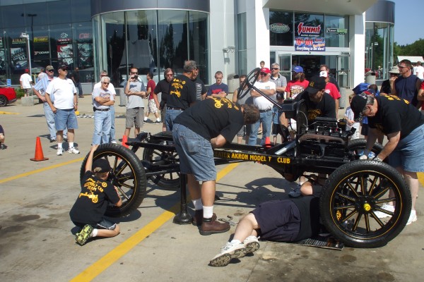 men assembling a ford model t demonstration, steering wheel