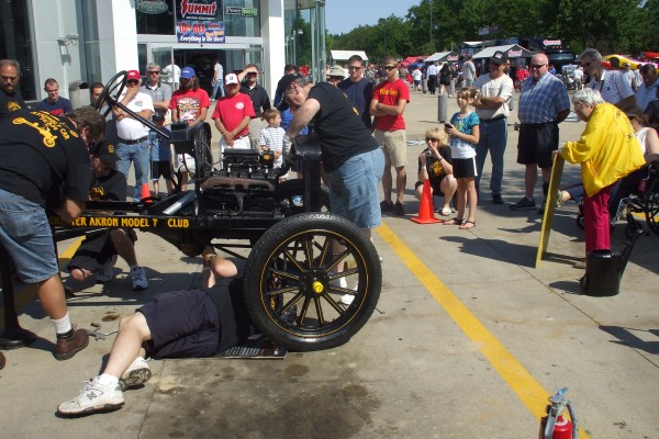 men assembling a ford model t demonstration, front