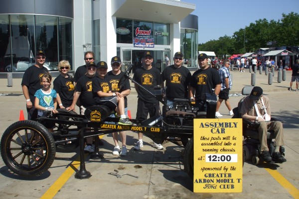 men posing with ford model t frame demo team