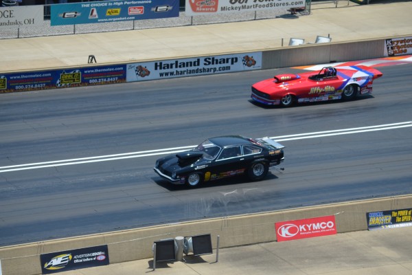 dragsters running down a dragstrip during race
