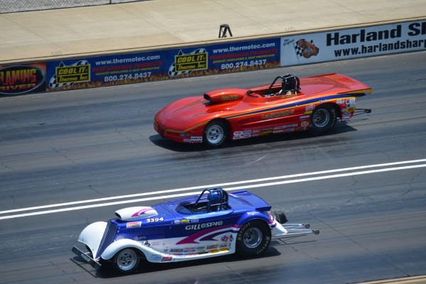a pair of drag race cars in mid-race