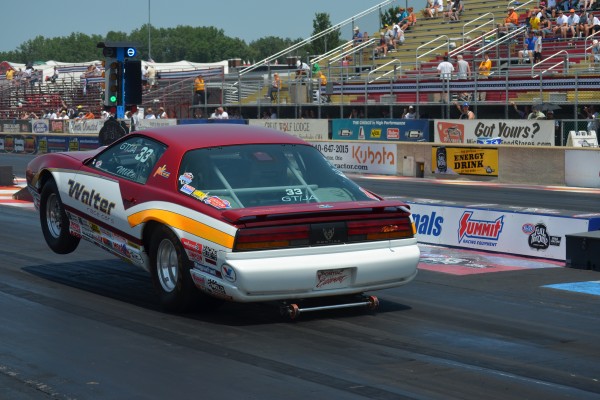 3rd gen firebird doing a wheelstand at launch of drag race