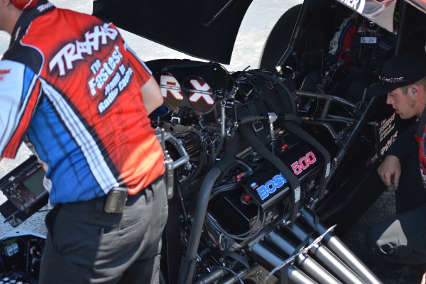 crews working on an nhra funny car engine