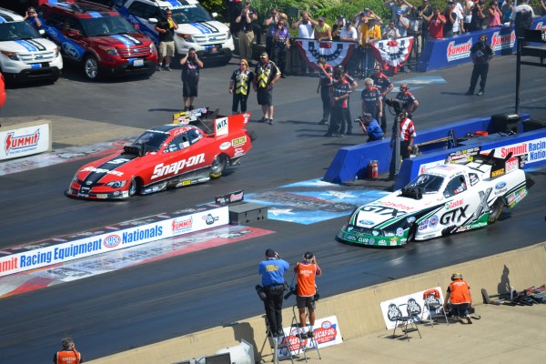 2 nhra funny cars staging for drag race, 2012