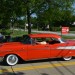 red 1957 chevy bel air with fender skirts thumbnail