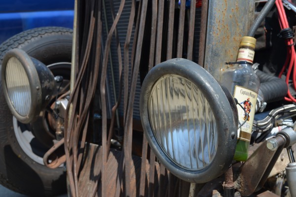 busted grille on a military themed ford rat rod tudor coupe