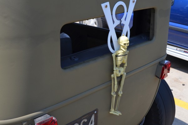 Skelton and v8 emblem on back of a rat rod coupe