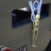 Skelton and v8 emblem on back of a rat rod coupe thumbnail