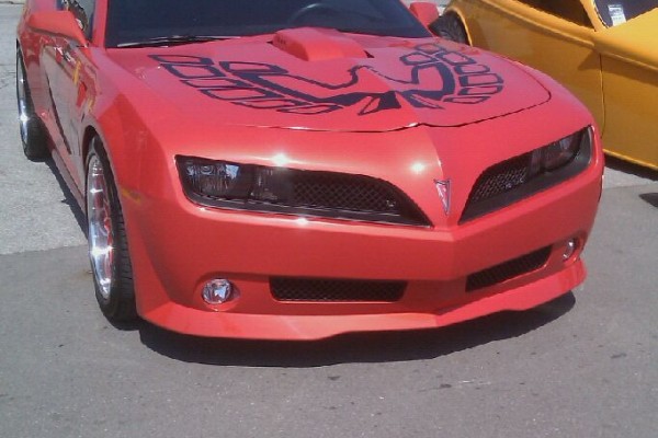 Red Firebird body kit on fifth gen Camaro