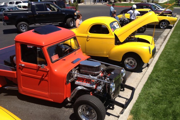 classic hot rods in a parking lot