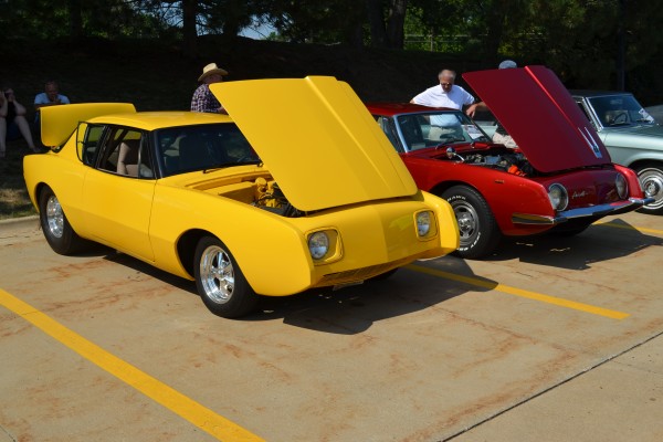 a pair of studebaker avanti sports cars