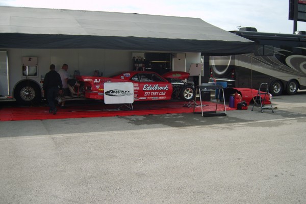a drag race pit crew servicing a car