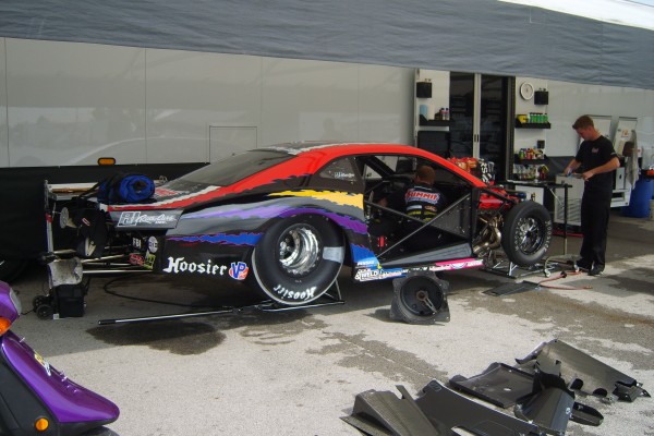 dragster getting serviced between races in pits