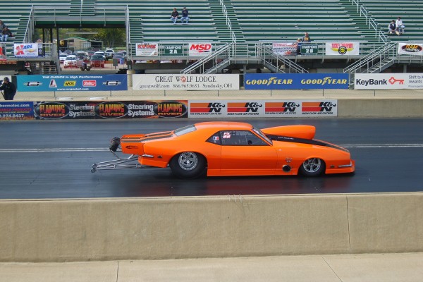 chevy camaro first gen on dragstrip during race