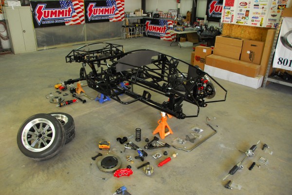 cobra kit car with parts spread out around chassis