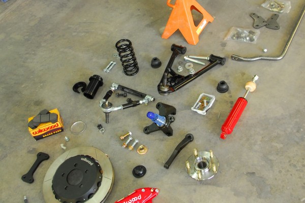 car parts for a cobra kit car resting on a floor