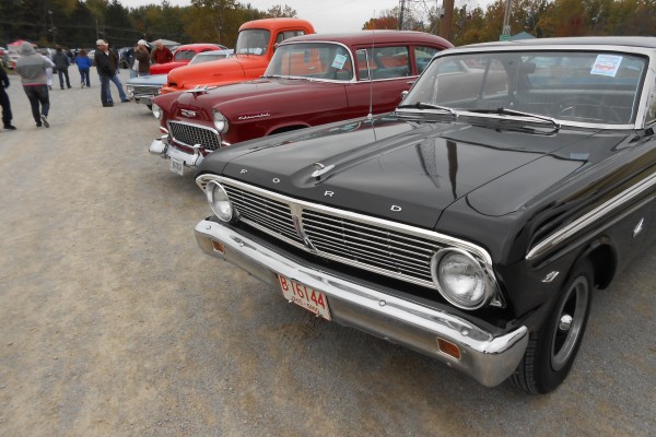 row of classic cars at a show