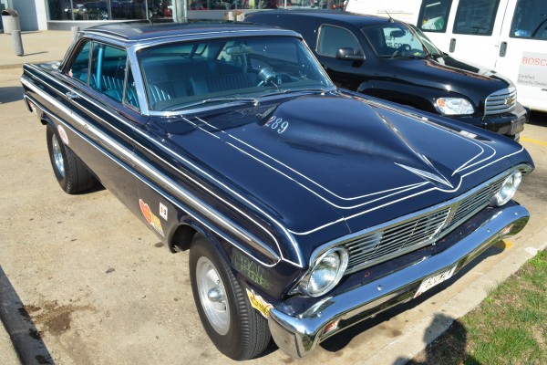 front of a customized 1965 Ford Falcon