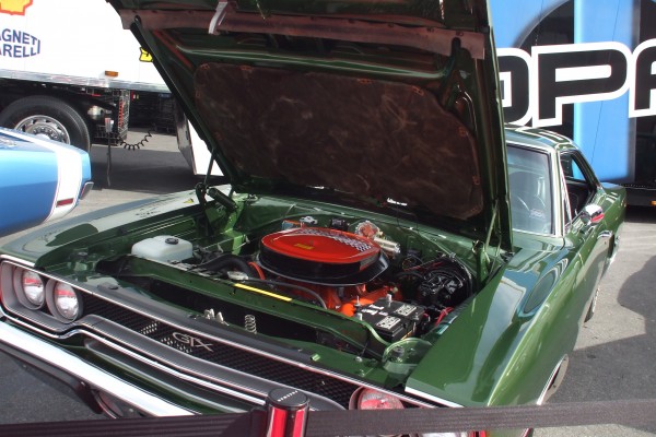vintage green plymouth gtx with hood up