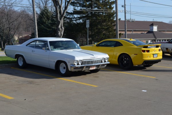 a white 1965 chevy impala 327 coupe and late model camaro