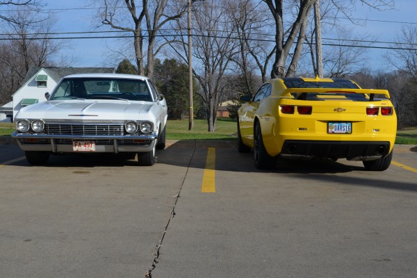 a white 1965 chevy impala 327 coupe and late model camaro