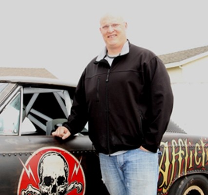 man posing with first-gen chevy chevelle muscle car